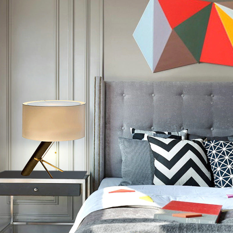 Asymmetrical black and brass table lamp in modern bedroom