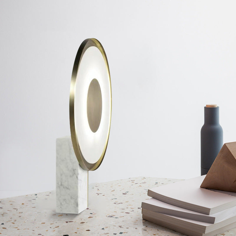 Side view of circular halo LED lamp with marble base and gold frame