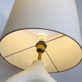 Sculptural off white resin loop table lamp with ivory fabric shade viewed from below