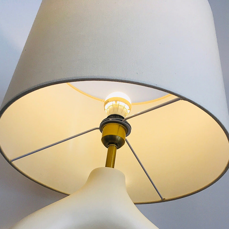 Sculptural off white resin loop table lamp with ivory fabric shade viewed from below