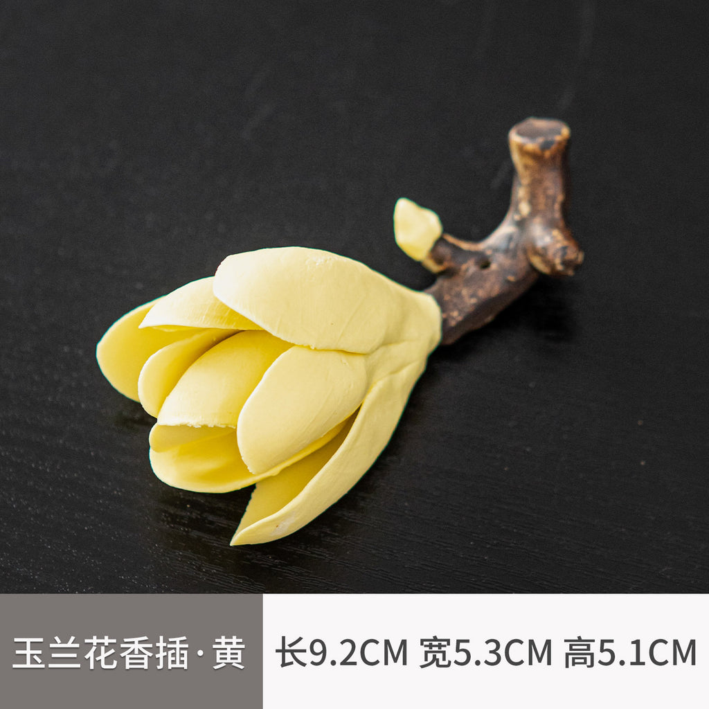 Yellow ceramic magnolia flower incense holder measuring 9.2 by 5.3 by 5.1 cm