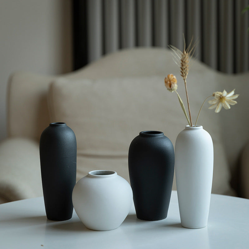 Matte black and white minimalist ceramic bud vases styled together