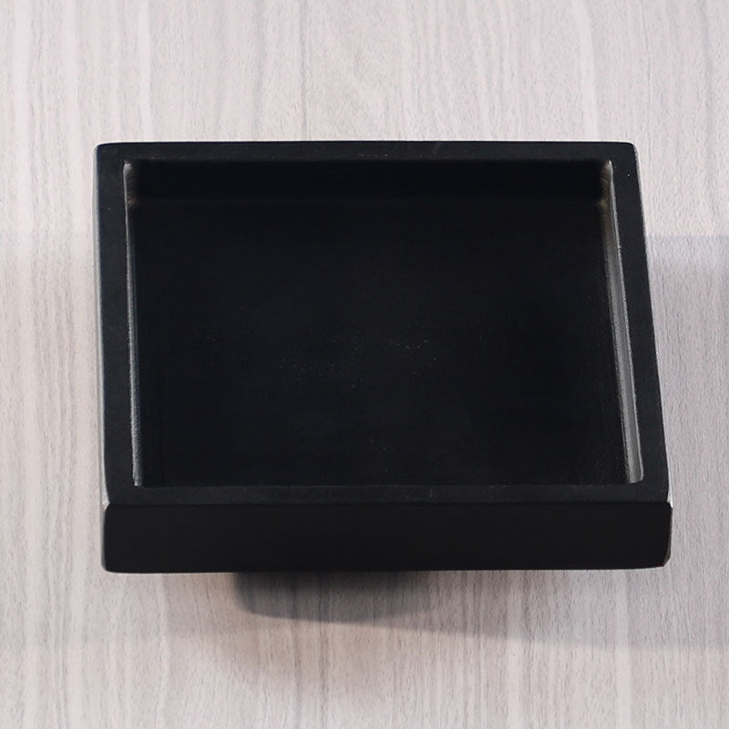 Square black stone planter basin with raised architectural rim
