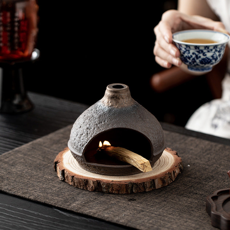Warm hill ceramic Palo Santo fireplace burner in tea room setting