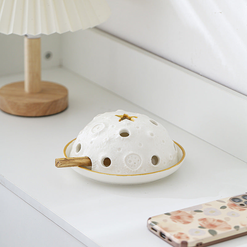 White star vent ceramic Palo Santo and sage burner styled on a bedside table