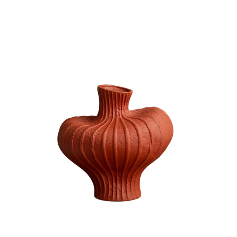 Terracotta red sculptural ribbed vase isolated on white background