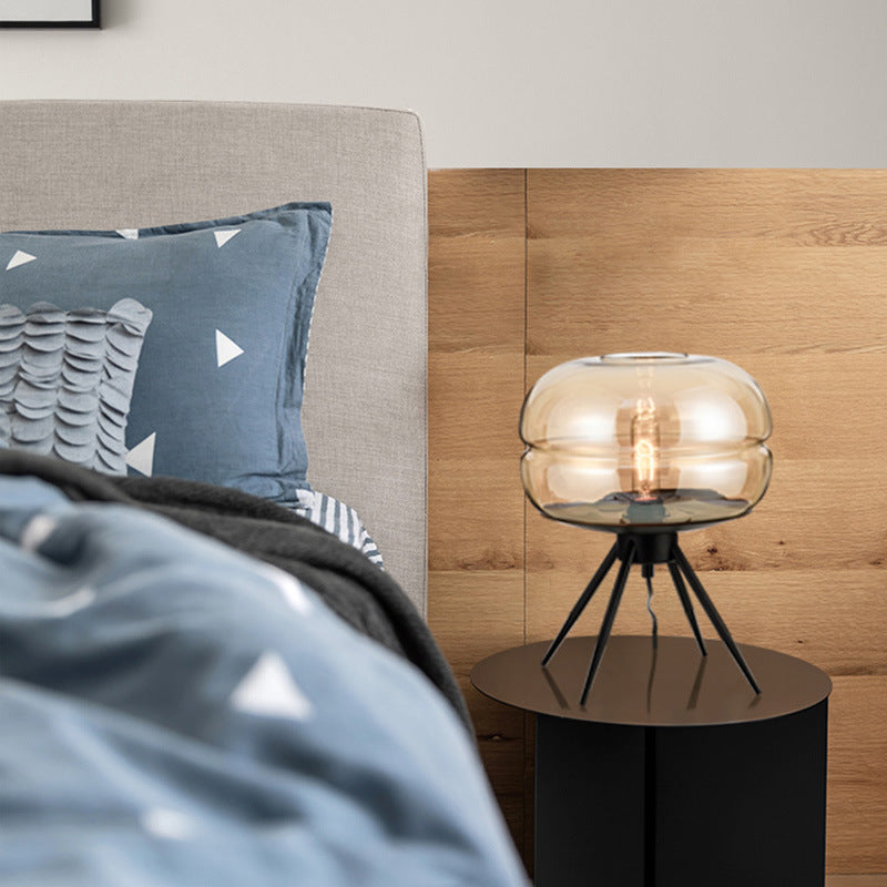 Amber glass tripod table lamp with exposed filament bulb