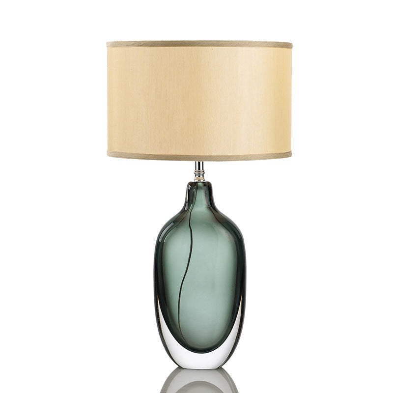 Smoke grey oval glass table lamp with beige fabric shade front view