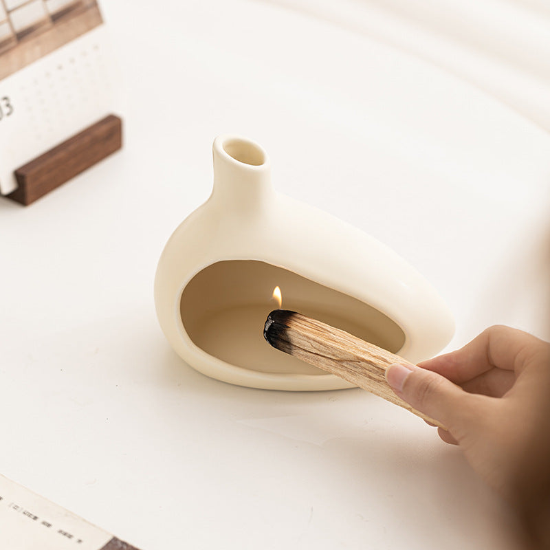 Ceramic Palo Santo burner in use with sacred wood stick and ash-catching chamber