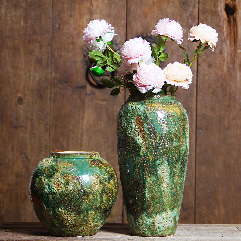 Rounded and tall green patina ceramic vases styled with white flowers
