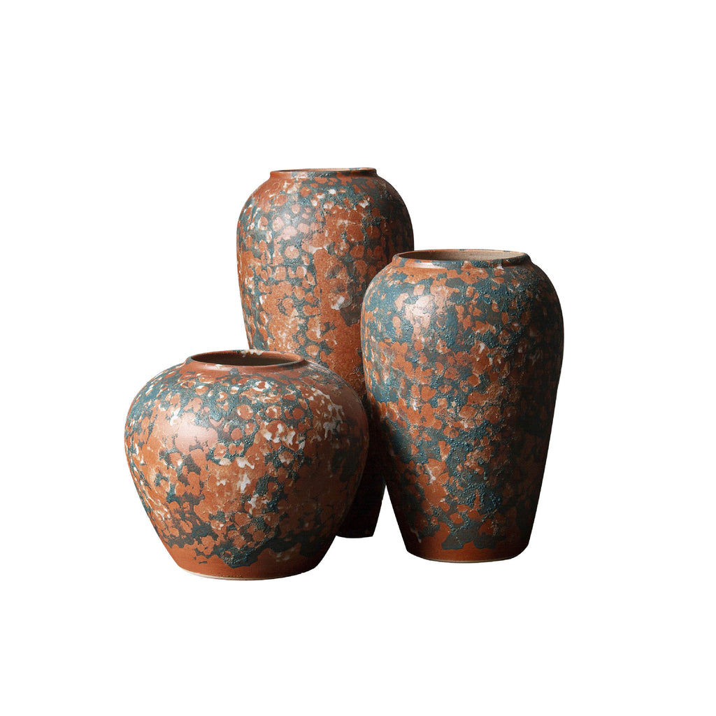 Terracotta orange and blue-green patina ceramic vase trio isolated on white
