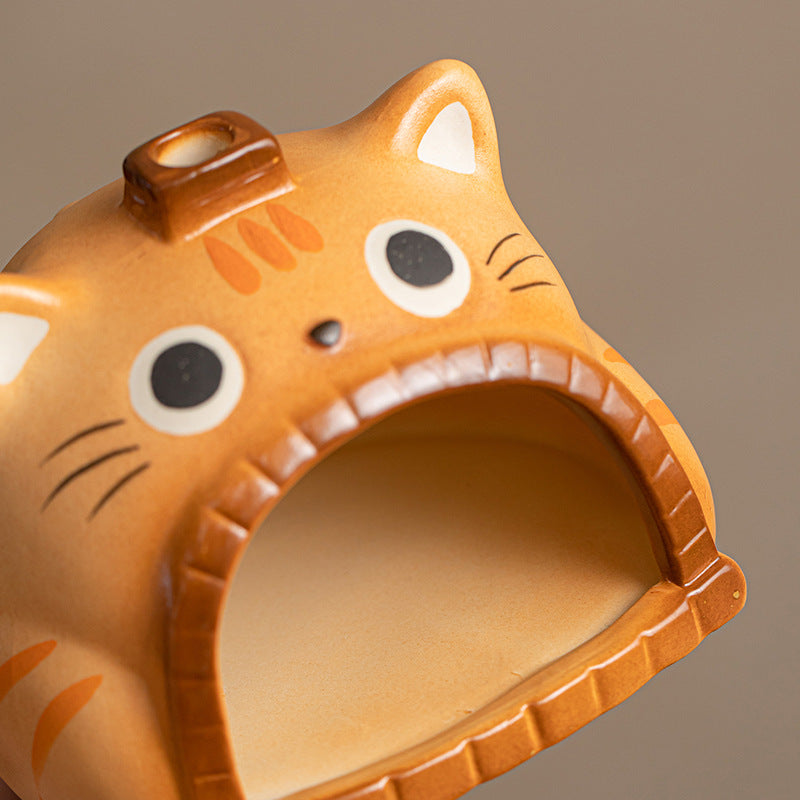 Close view of orange cat ceramic ritual burner with large hearth opening