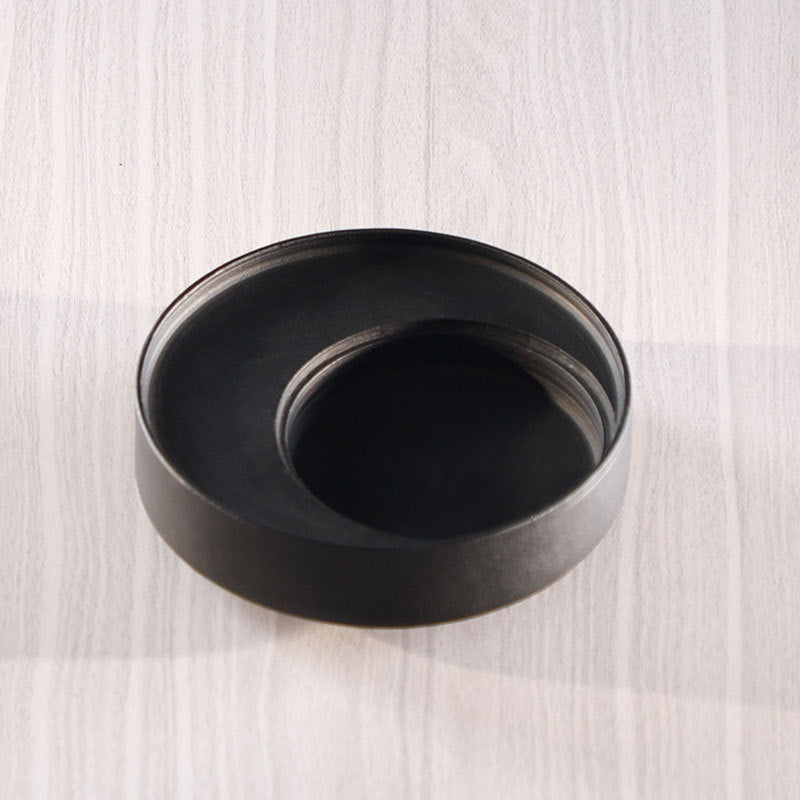 Round black stone bonsai and moss garden basin
