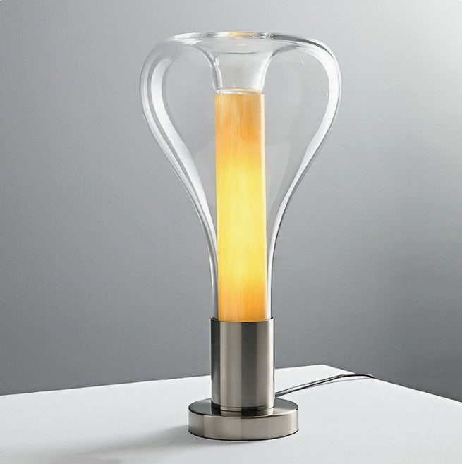Clear glass capsule lamp with warm golden inner diffuser