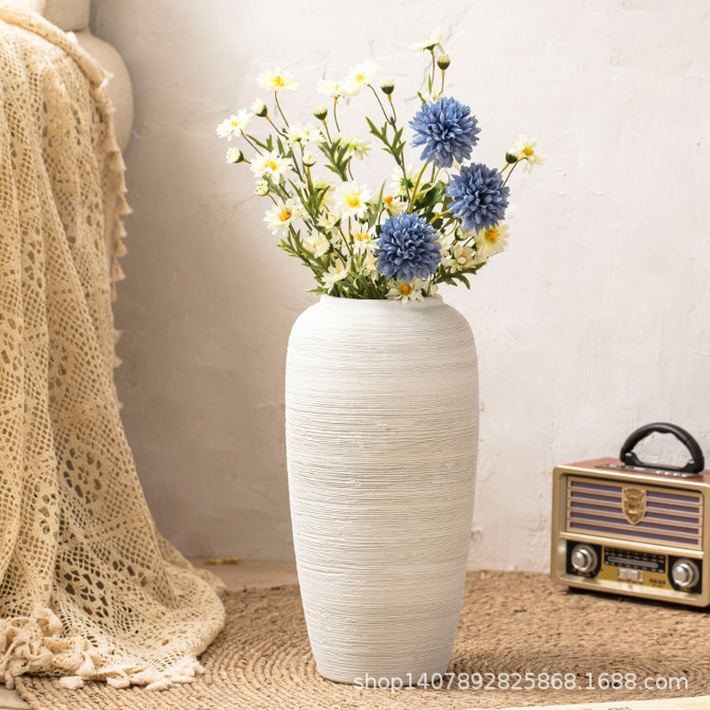 Ivory white ribbed ceramic floor vase styled with flowers