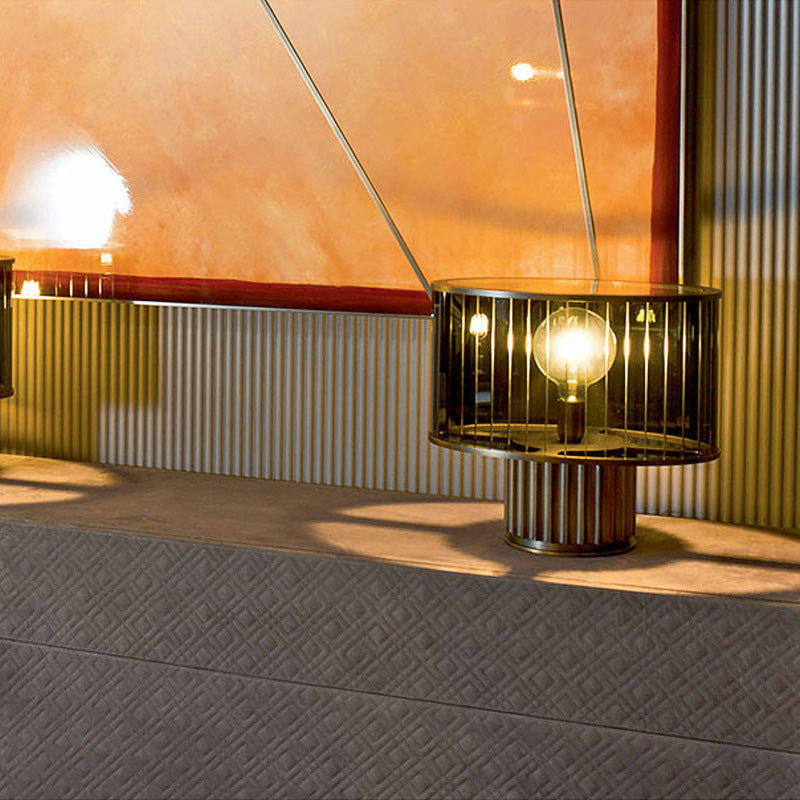 Smoke grey cylindrical glass table lamp with vertical cage detail and ribbed base