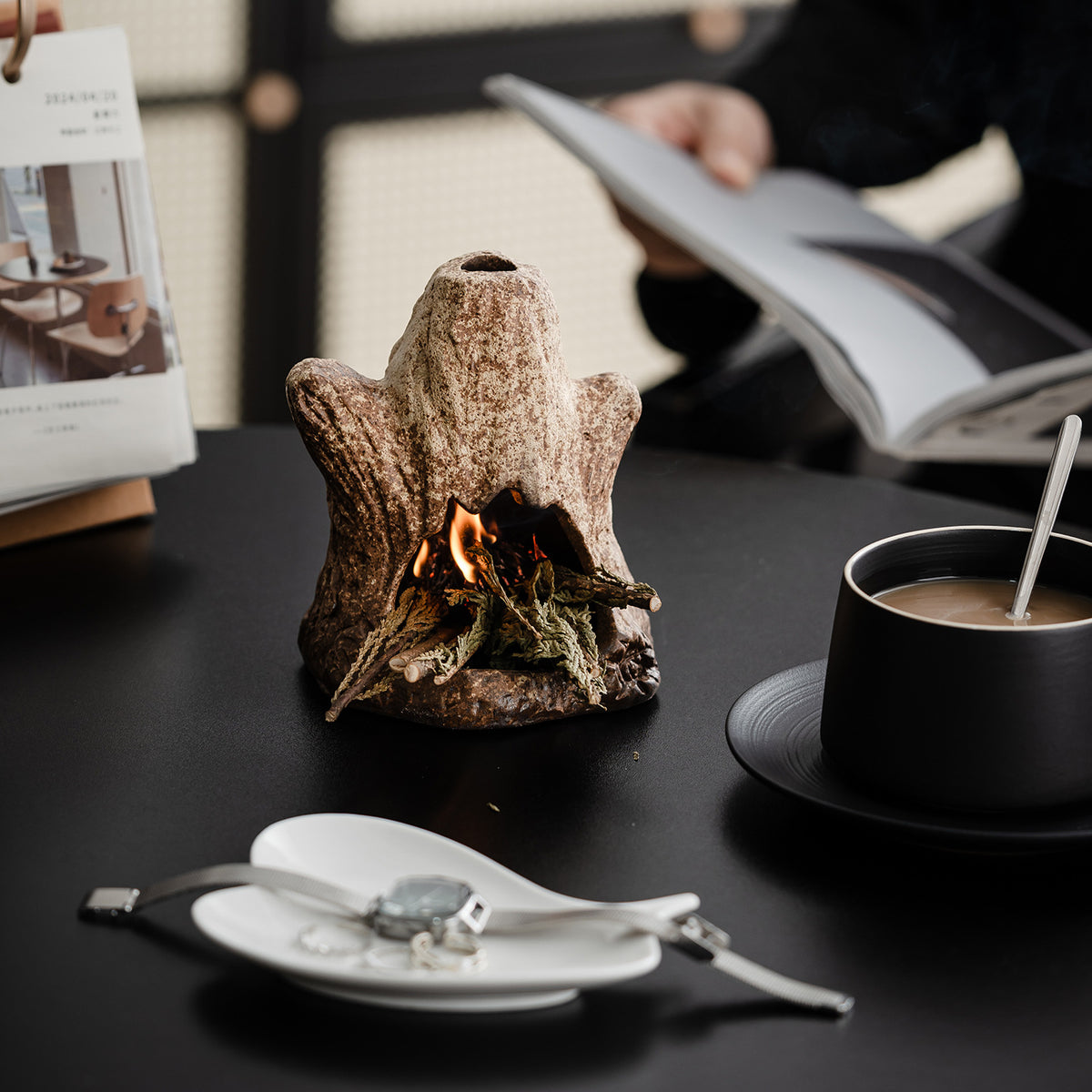 Tree stump ceramic ritual fireplace burning sage in a modern tea setting
