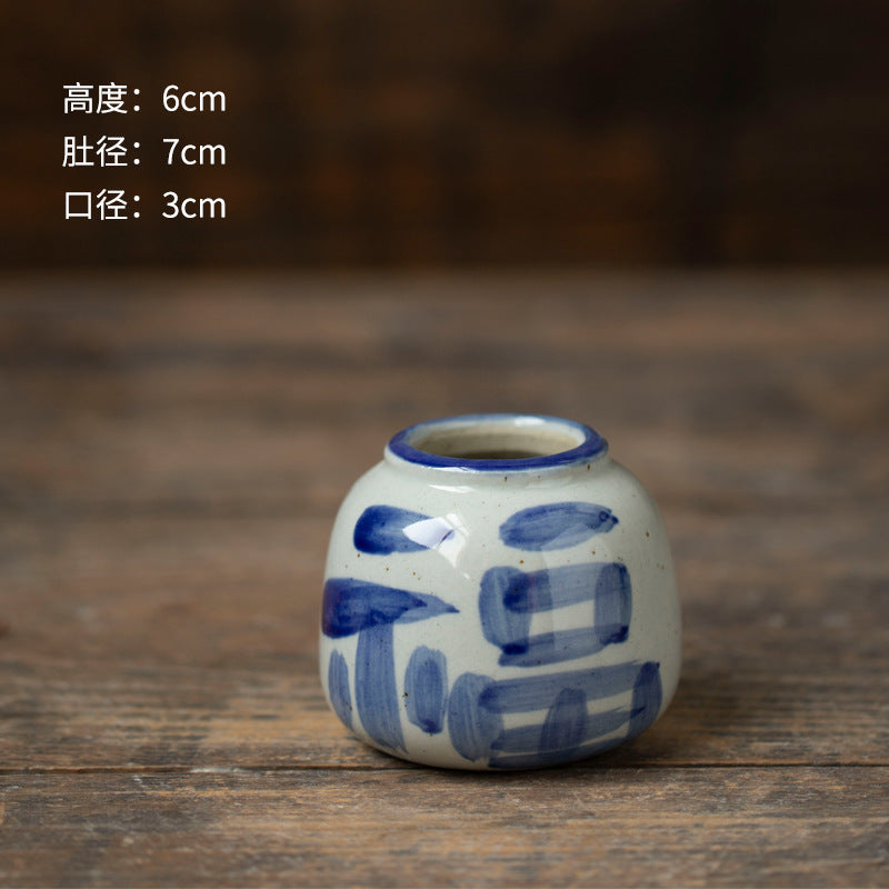 Hand-painted blue white round ceramic bud vase with abstract motif, 6 cm