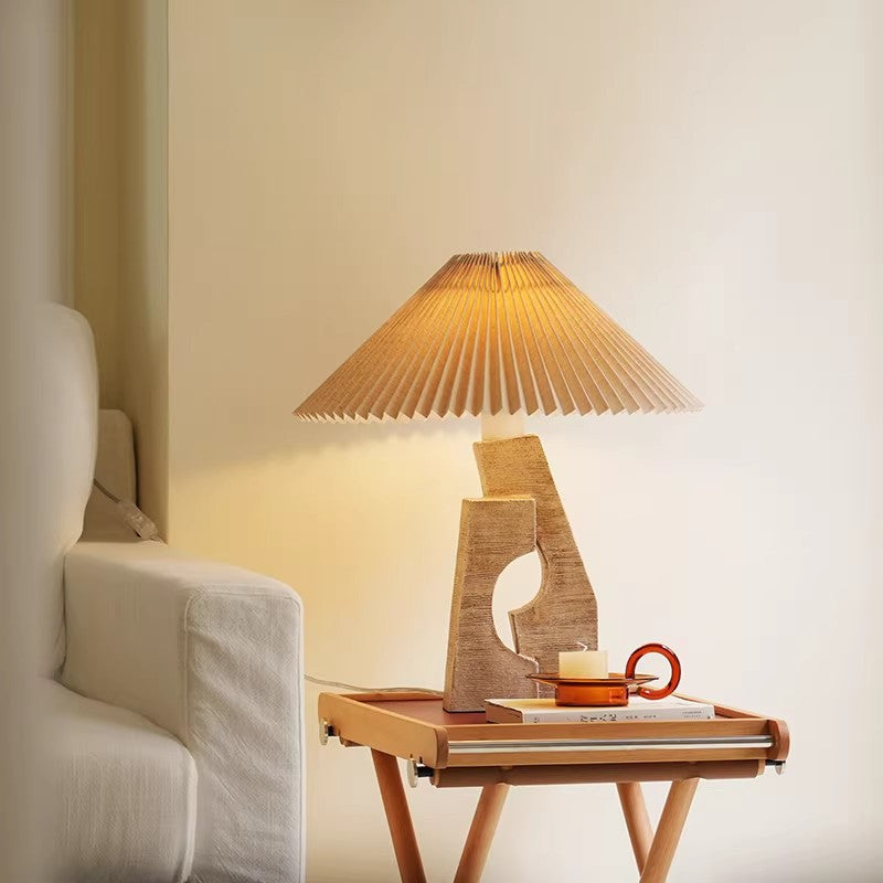 Beige sculptural pleated shade bedside lamp styled in bedroom