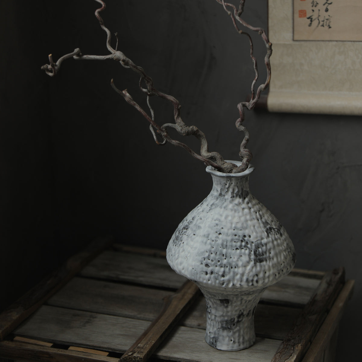 Mottled white rustic ceramic vase with dark twisting branches