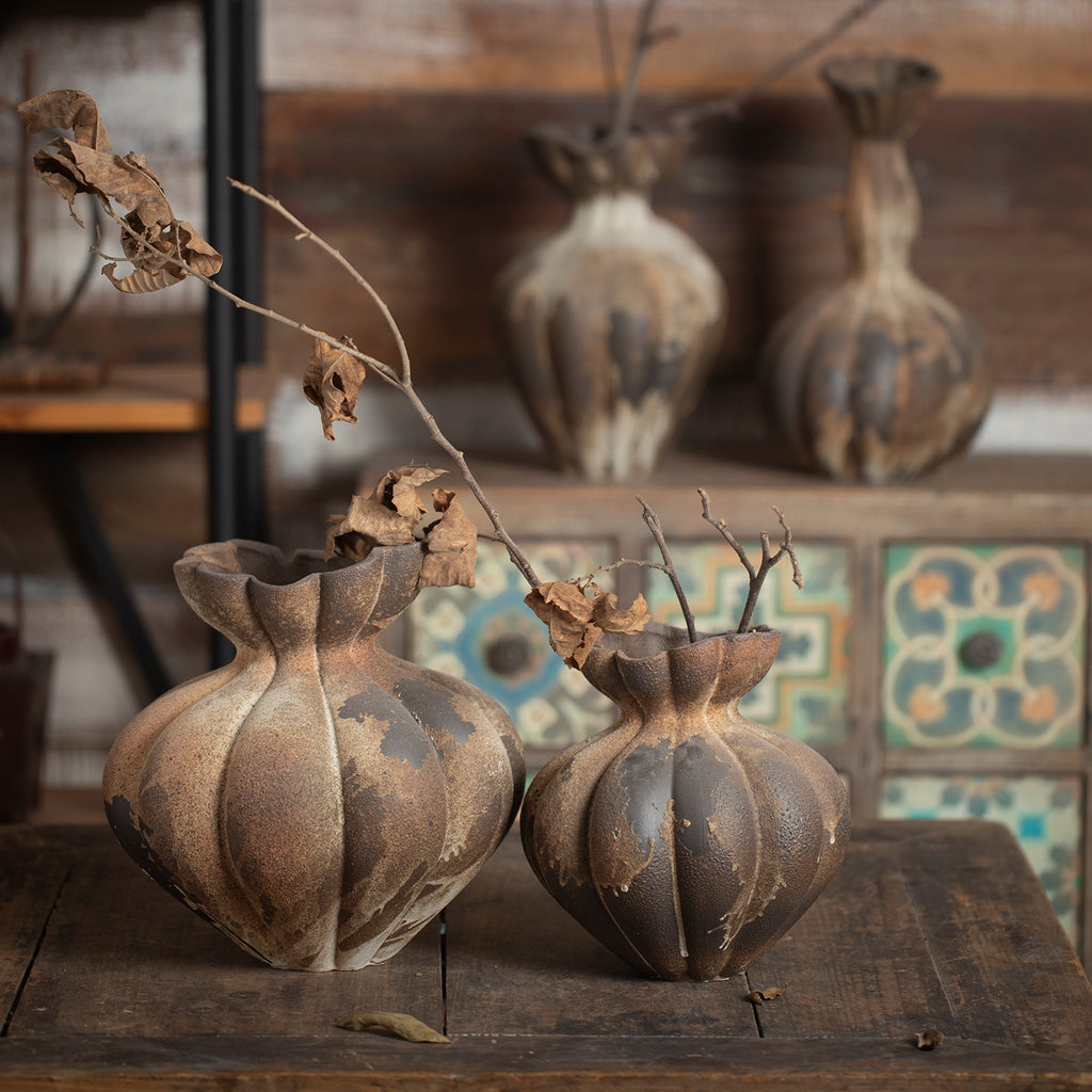 Aged rust brown fluted gourd ceramic vases styled on rustic table