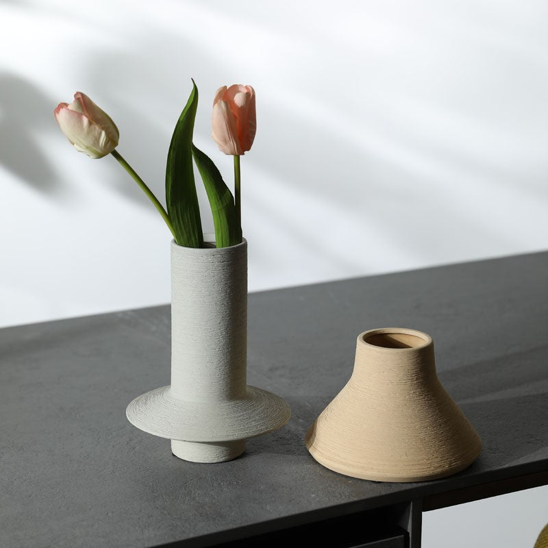 Grey cylinder and sand yellow textured ceramic vases styled with tulips