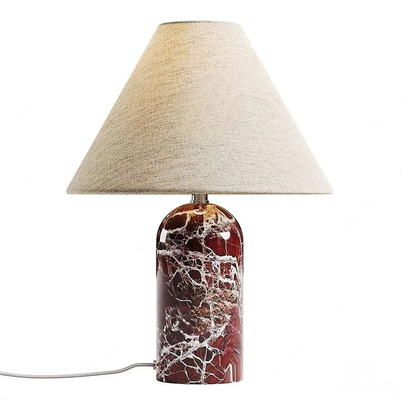 Close view of purple marble veining and beige fabric shade table lamp