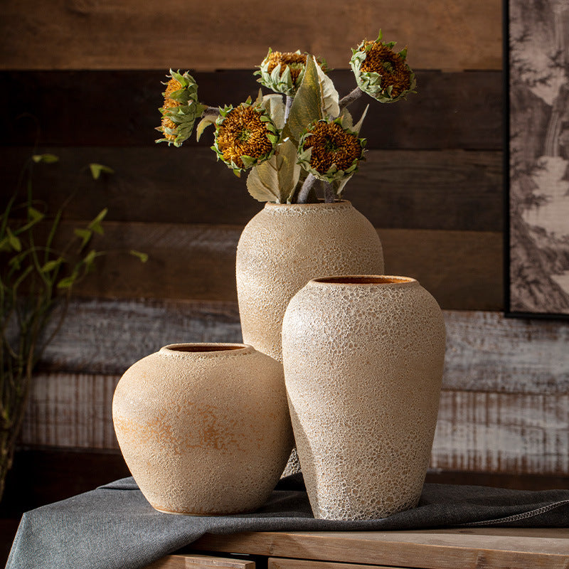 Three beige sand-texture vases in rounded and tall shapes