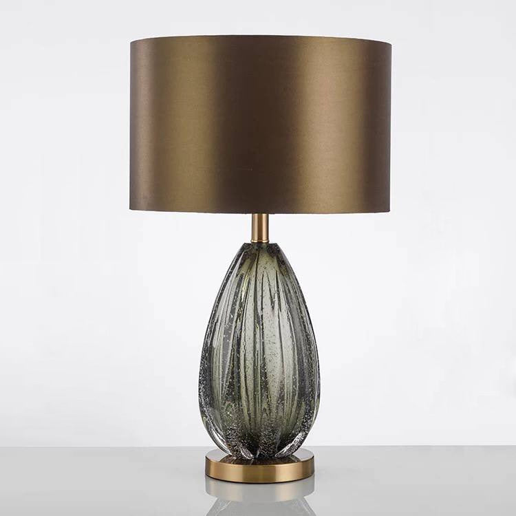 Grey green ribbed glass table lamp detail with electroplated brass base