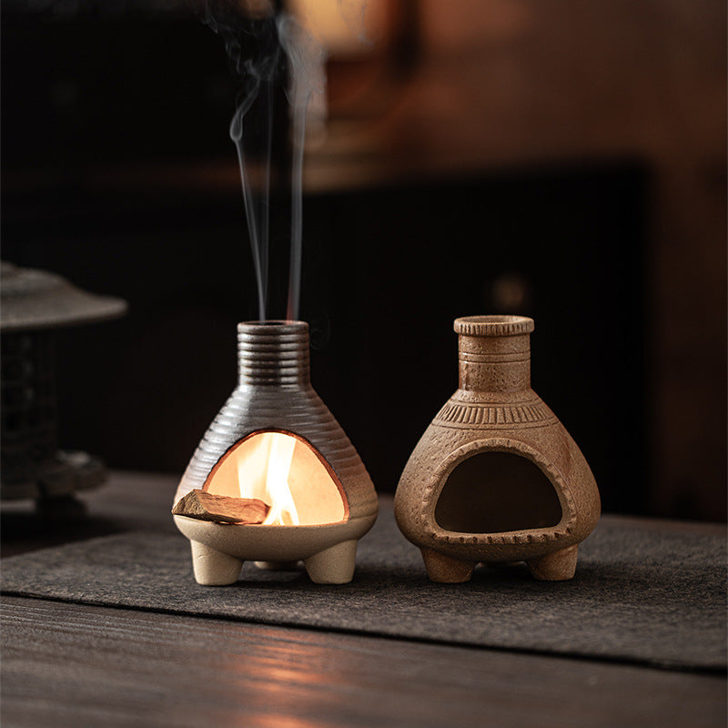 Natural sand and charcoal ribbed ceramic ritual fireplaces displayed together