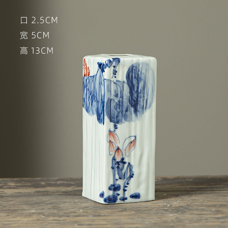 Hand-painted blue white rectangular ceramic bud vase with figure motif, 13 cm