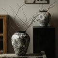 Black and white snow-texture ceramic vase with bare branches