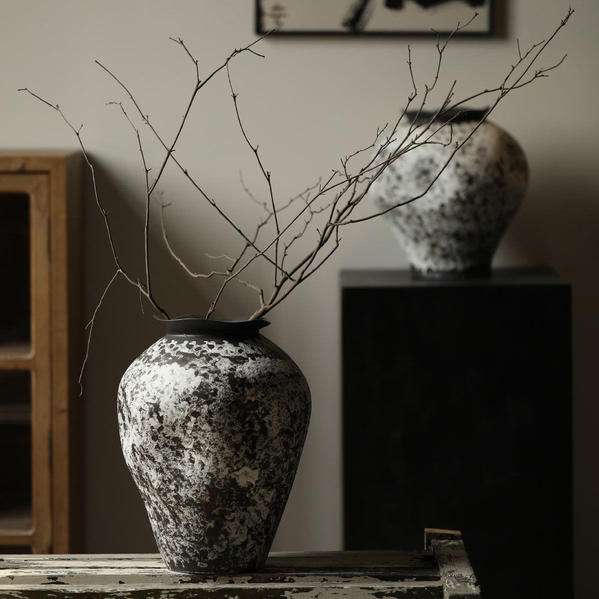 Black and white snow-texture ceramic vase with bare branches