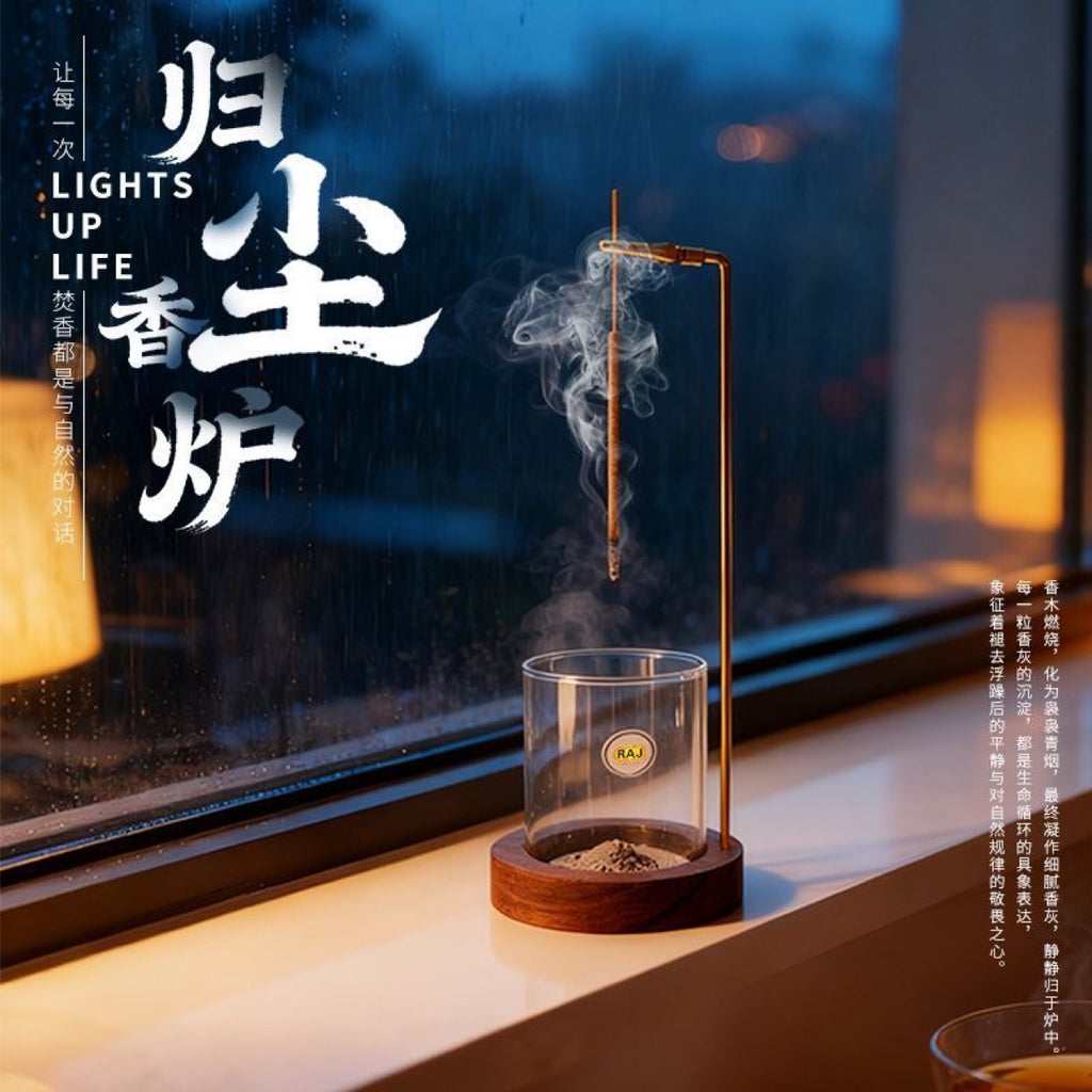 Hanging incense stick burner with glass ash catcher styled by a window