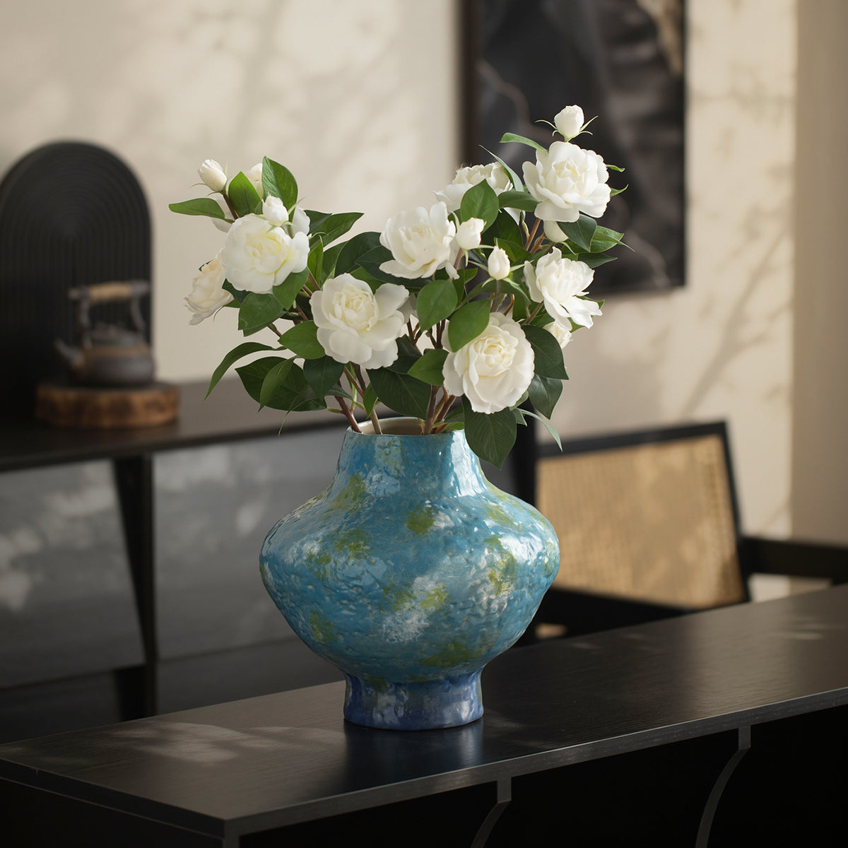 Turquoise blue mottled ceramic vase with white camellia flowers