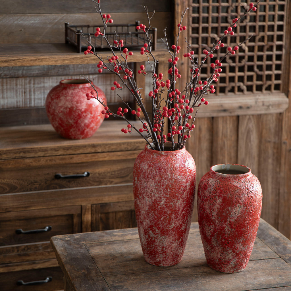 Berry red ceramic vases with festive red branch arrangement