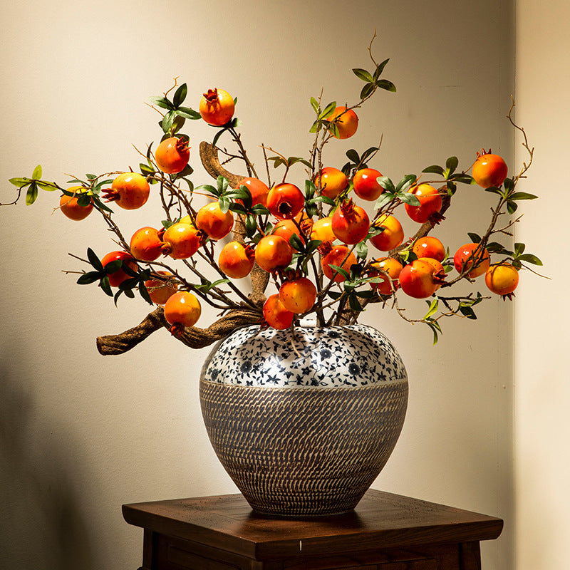 Blue and white floral ceramic jar with orange persimmon branches