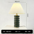 Green stacked disc resin table lamp 35cm by 50cm with tapered fabric shade