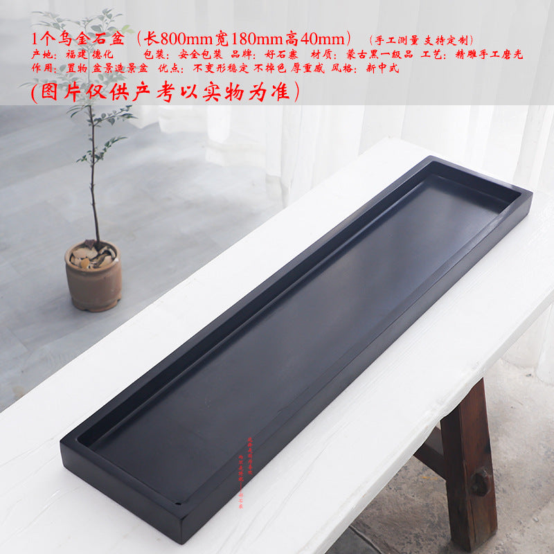 Long black stone tray with circular planting well and rectangular water section