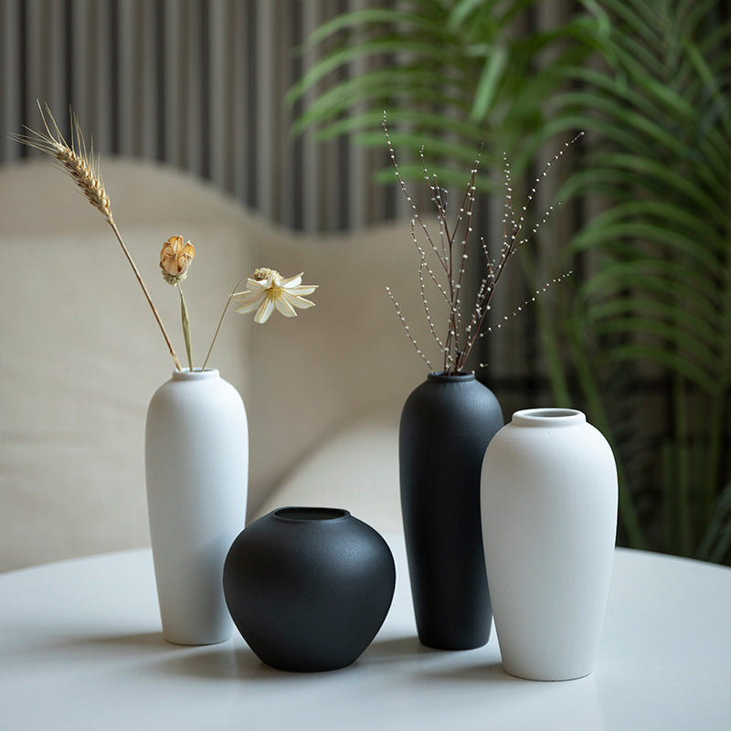 Matte black and white minimalist ceramic bud vase group with dried stems
