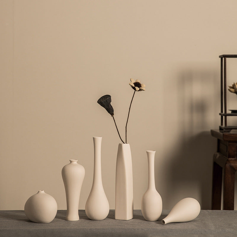 Matte ivory mini ceramic bud vase collection in warm Zen interior
