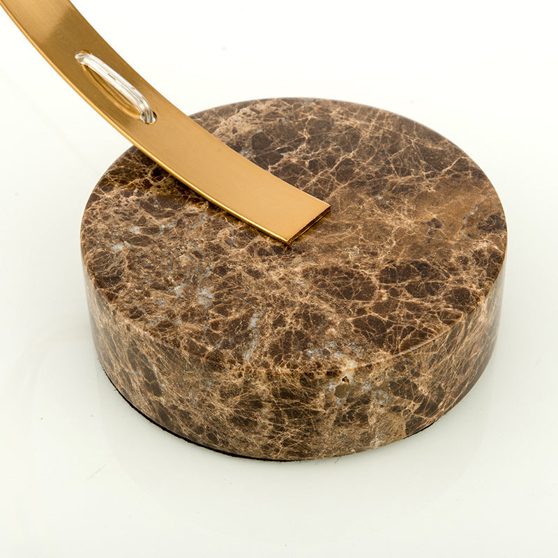 Round brown marble base and brass arc detail on designer table lamp