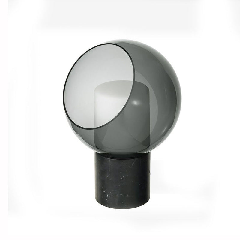 Smoke grey glass orb and black marble sculptural table lamp front view
