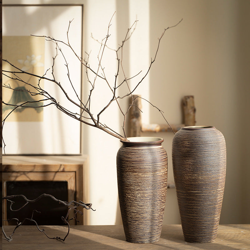 Brown ribbed ceramic vase pair with bare branches