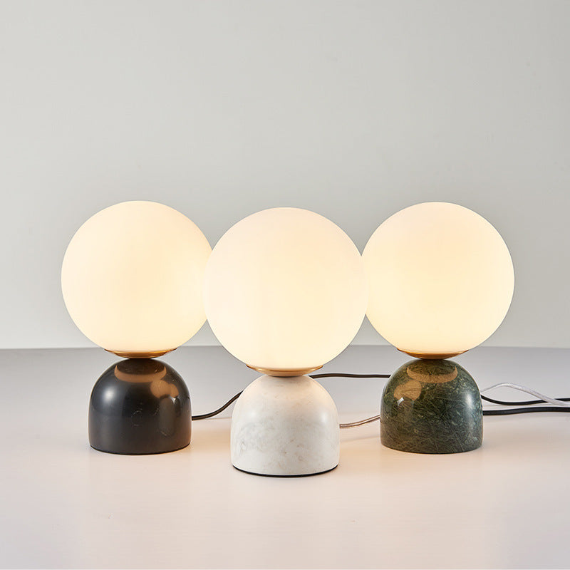 Black white and green marble globe table lamps grouped together