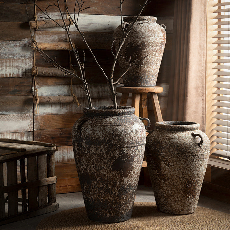 Large rustic double-handle ceramic urns with bare branches