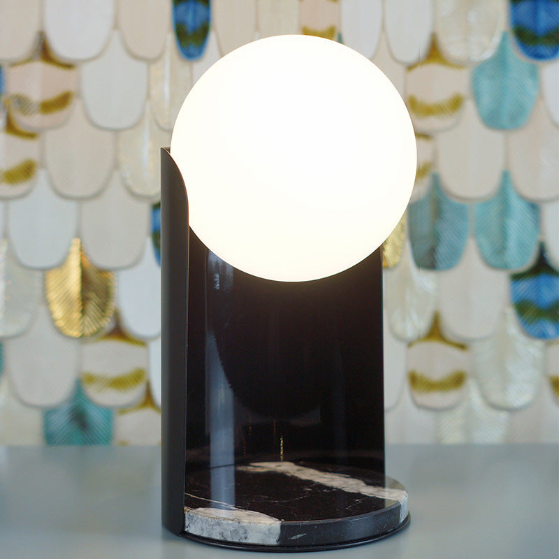 Black architectural globe table lamp with opal glass sphere