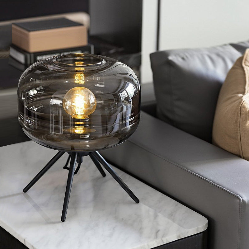 Smoke grey glass tripod table lamp in modern living room