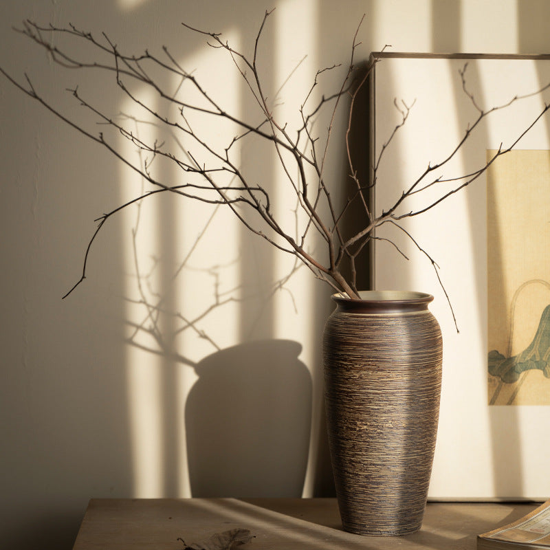 Brown ribbed ceramic vase styled in warm New Chinese interior