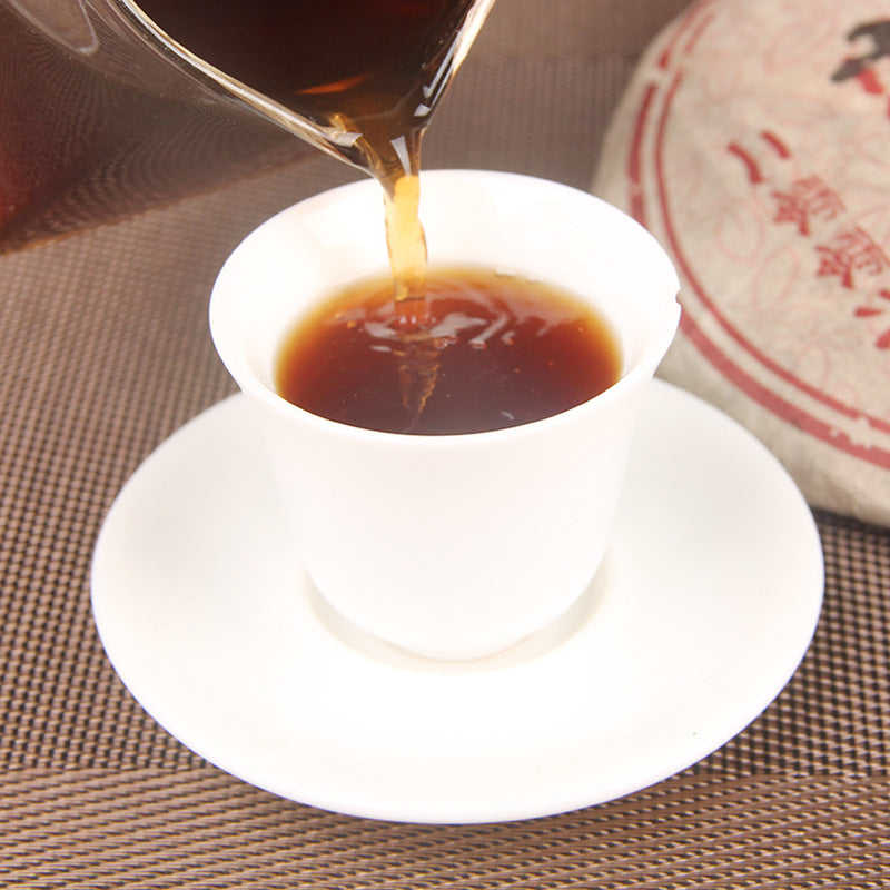 2006 Peacock Homeland aged ripe Pu-erh tea cake packaging and tea display 孔雀之乡